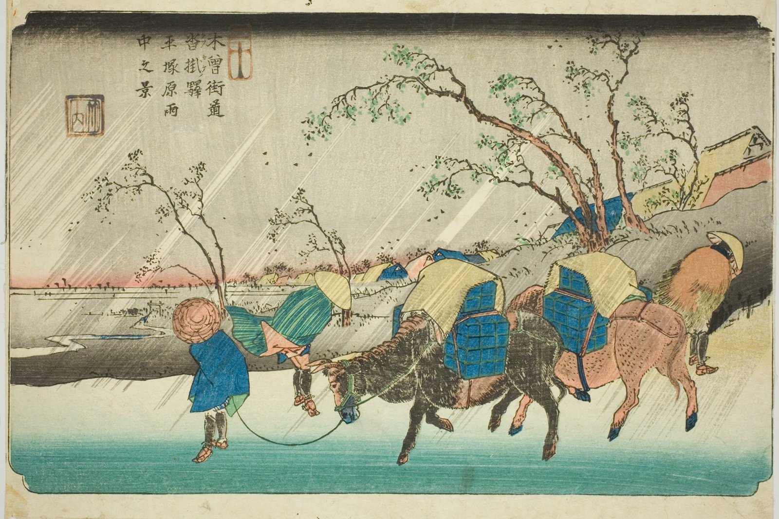 渓斎英泉「木曾街道六十九次 平塚原 雨中之景」。強い斜めの雨の中、荷を背負った馬を引く人々が頭を下げて歩いている。夕暮れの赤い空と、風にしなる裸木の枝が描かれている